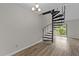 Bright room featuring a spiral staircase and a chandelier at 3077 Huntleigh Dr, Raleigh, NC 27604