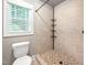 Tiled shower and toilet area in bathroom, providing functionality and style at 325 Martin Luther King Jr Blvd, Raleigh, NC 27601
