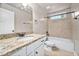Bright bathroom with granite counters and neutral-colored tile in the shower at 325 Martin Luther King Jr Blvd, Raleigh, NC 27601