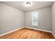 Neutral bedroom with hardwood floors and single window with closed blinds at 325 Martin Luther King Jr Blvd, Raleigh, NC 27601