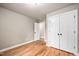 Neutral bedroom with hardwood floors features closet and an open doorway at 325 Martin Luther King Jr Blvd, Raleigh, NC 27601