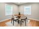 Bright dining area featuring a wood table, seating for four, and natural light from two windows at 325 Martin Luther King Jr Blvd, Raleigh, NC 27601