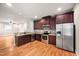 Modern kitchen featuring stainless steel appliances, granite countertops, and wooden cabinets at 325 Martin Luther King Jr Blvd, Raleigh, NC 27601