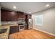 Modern kitchen features stainless steel appliances, granite countertops, and dark wood cabinets at 325 Martin Luther King Jr Blvd, Raleigh, NC 27601