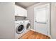 Bright laundry room features white washer, dryer, cabinets, and access door at 325 Martin Luther King Jr Blvd, Raleigh, NC 27601