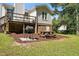 Spacious backyard featuring a grill, wooden picnic table, and mulched ground at 364 Chinaberry Ln, Angier, NC 27501