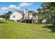 Backyard featuring wooden deck, picnic table, and trampoline with sprawling green lawn at 364 Chinaberry Ln, Angier, NC 27501