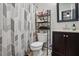 Bathroom featuring a vanity with a dark wood cabinet, toilet, and shower with patterned curtain at 364 Chinaberry Ln, Angier, NC 27501