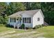 Quaint single-story home with a cozy porch, complemented by landscaped garden and lawn at 364 Chinaberry Ln, Angier, NC 27501