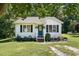 Charming single-story home with blue door and manicured front lawn and classic siding at 364 Chinaberry Ln, Angier, NC 27501