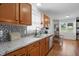 Well-lit kitchen with double sink, stainless appliances, and tile backsplash at 364 Chinaberry Ln, Angier, NC 27501