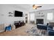 Cozy living room with fireplace, ceiling fan, television, and comfortable blue couch at 364 Chinaberry Ln, Angier, NC 27501