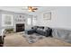 Living room featuring a fireplace, ceiling fan, and a comfortable blue couch with throw pillows at 364 Chinaberry Ln, Angier, NC 27501