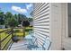 Enclosed patio with blue seating, wooden deck, and view of landscaped backyard at 364 Chinaberry Ln, Angier, NC 27501