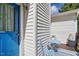 Enclosed patio space featuring blue outdoor seating, a door, and white siding at 364 Chinaberry Ln, Angier, NC 27501
