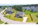Brick home with manicured lawn, long driveway and mature trees in a residential neighborhood at 367 Tayside St, Clayton, NC 27520