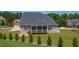 Spacious backyard with a fire pit, screened porch, and lush green lawn at 367 Tayside St, Clayton, NC 27520