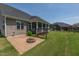 Serene backyard retreat featuring a fire pit, porch swing, lush landscaping, and green grass at 367 Tayside St, Clayton, NC 27520