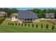 Expansive backyard features a manicured lawn, fire pit, and views of the surrounding neighborhood at 367 Tayside St, Clayton, NC 27520