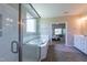 This bathroom has a glass door shower with bathtub and view to bedroom at 367 Tayside St, Clayton, NC 27520
