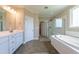 The bathroom has double sinks, a bathtub, and a glass door shower at 367 Tayside St, Clayton, NC 27520