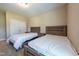 Bedroom featuring two beds with matching wood headboards, offering a comfortable space with natural light at 367 Tayside St, Clayton, NC 27520
