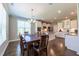 Bright dining area features hardwood floors, modern chandelier, and lots of natural light at 367 Tayside St, Clayton, NC 27520