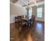 Light-filled dining area features a coffered ceiling, wainscoting, modern chandelier, and gleaming hardwood floors at 367 Tayside St, Clayton, NC 27520