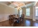 Dining room showcases coffered ceiling, wainscoting, natural light, chandelier, and hardwood floors at 367 Tayside St, Clayton, NC 27520