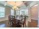 Inviting dining room with coffered ceilings, wainscoting, and hardwood floors that lead to other parts of the house at 367 Tayside St, Clayton, NC 27520