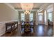 Dining room featuring coffered ceilings, wainscoting, modern chandelier, and hardwood floors, with front door visible at 367 Tayside St, Clayton, NC 27520