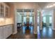 Bright dining room featuring a coffered ceiling, stylish chandelier, and dark wood floors, connecting to other living spaces at 367 Tayside St, Clayton, NC 27520