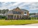 Attractive brick home featuring black shutters, a covered porch, and a landscaped front yard at 367 Tayside St, Clayton, NC 27520
