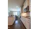 Modern kitchen featuring white cabinets, granite countertops, and stainless steel appliances at 367 Tayside St, Clayton, NC 27520