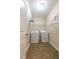 Functional laundry room features a washer, dryer, shelving, and neutral decor at 367 Tayside St, Clayton, NC 27520