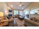 The living room has a fireplace, couches, and entry to dining room and kitchen at 367 Tayside St, Clayton, NC 27520