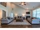 Inviting living room featuring a fireplace, ceiling fan, and hardwood floors, creating a cozy and stylish atmosphere at 367 Tayside St, Clayton, NC 27520