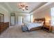 This main bedroom has neutral carpet with a tray ceiling and natural lighting at 367 Tayside St, Clayton, NC 27520