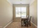 This office has neutral carpet with a window letting in natural light and view of the yard at 367 Tayside St, Clayton, NC 27520