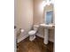 The powder room features a pedestal sink and wooden floor at 367 Tayside St, Clayton, NC 27520