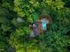 A high aerial shot revealing a home with a pool nestled amongst mature trees providing privacy and tranquility at 3910 Somerset Dr, Durham, NC 27707