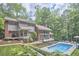 This home has a backyard that features a pool, an expansive deck, and a lushly landscaped yard at 3910 Somerset Dr, Durham, NC 27707