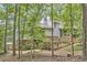 Backyard of this beautiful home features a wooden deck, and a tranquil setting surrounded by lush greenery at 3910 Somerset Dr, Durham, NC 27707