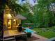 A backyard with a pool, deck, pergola, grill and lush landscaping at 3910 Somerset Dr, Durham, NC 27707