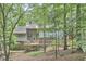 Secluded backyard with beautiful wooden deck and surrounding lush trees offers a private outdoor retreat at 3910 Somerset Dr, Durham, NC 27707
