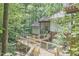 Backyard of this house showcasing multiple decks, offering scenic views and serene surroundings nestled amongst mature trees at 3910 Somerset Dr, Durham, NC 27707