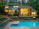 The backyard of this beautiful home features a sparkling pool and a spacious deck for outdoor relaxation at 3910 Somerset Dr, Durham, NC 27707