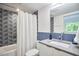 Modern bathroom featuring a stylish vanity, geometric tile, and bathtub with shower at 3910 Somerset Dr, Durham, NC 27707