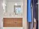 Modern bathroom with dual sinks, wood vanity, and stylish pendant lighting at 3910 Somerset Dr, Durham, NC 27707