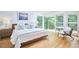 Bright bedroom features hardwood floors, large windows, and modern furnishings at 3910 Somerset Dr, Durham, NC 27707